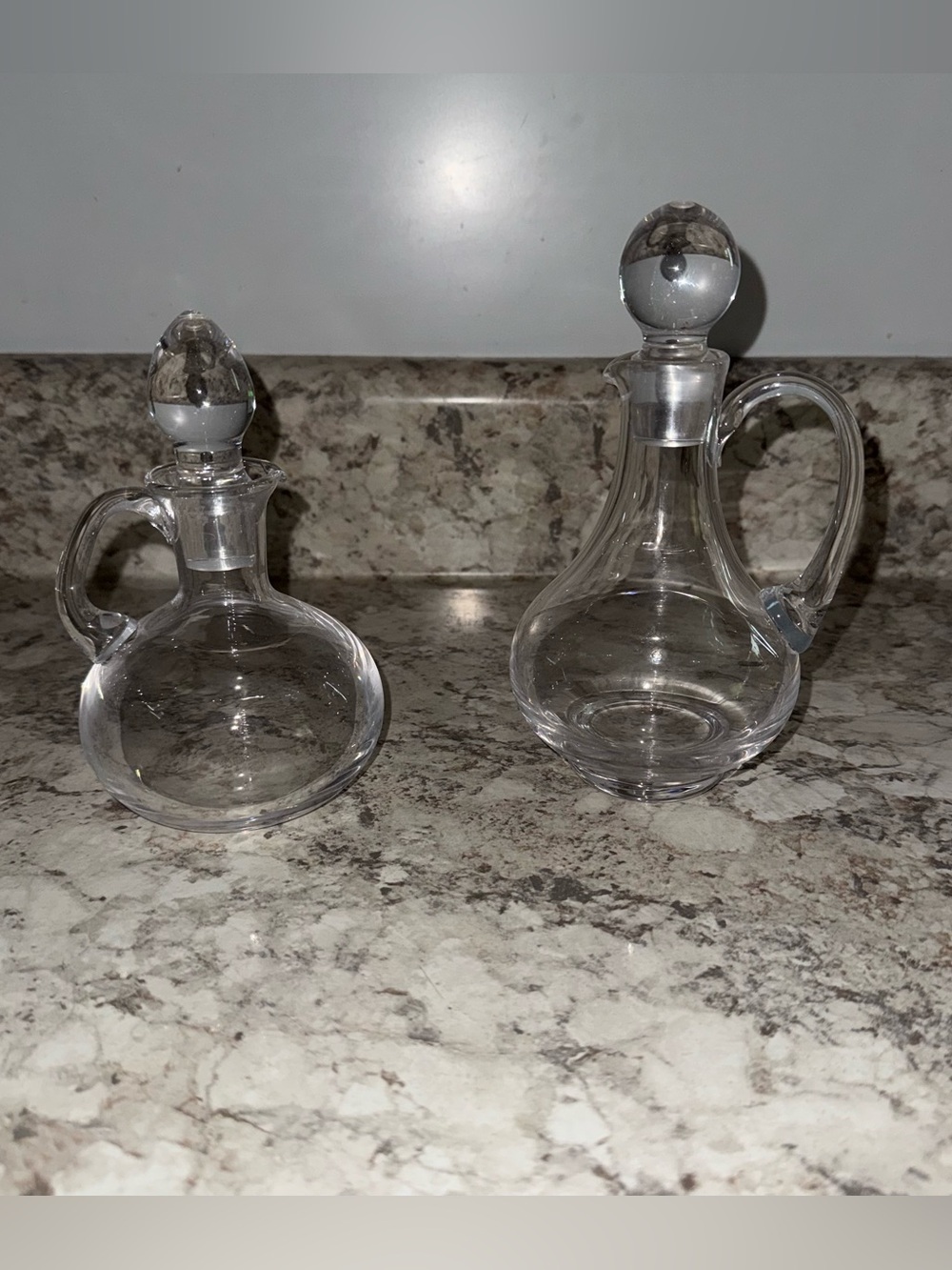 clear glass oil and vinegar cruets with handles and ground glass stoppers